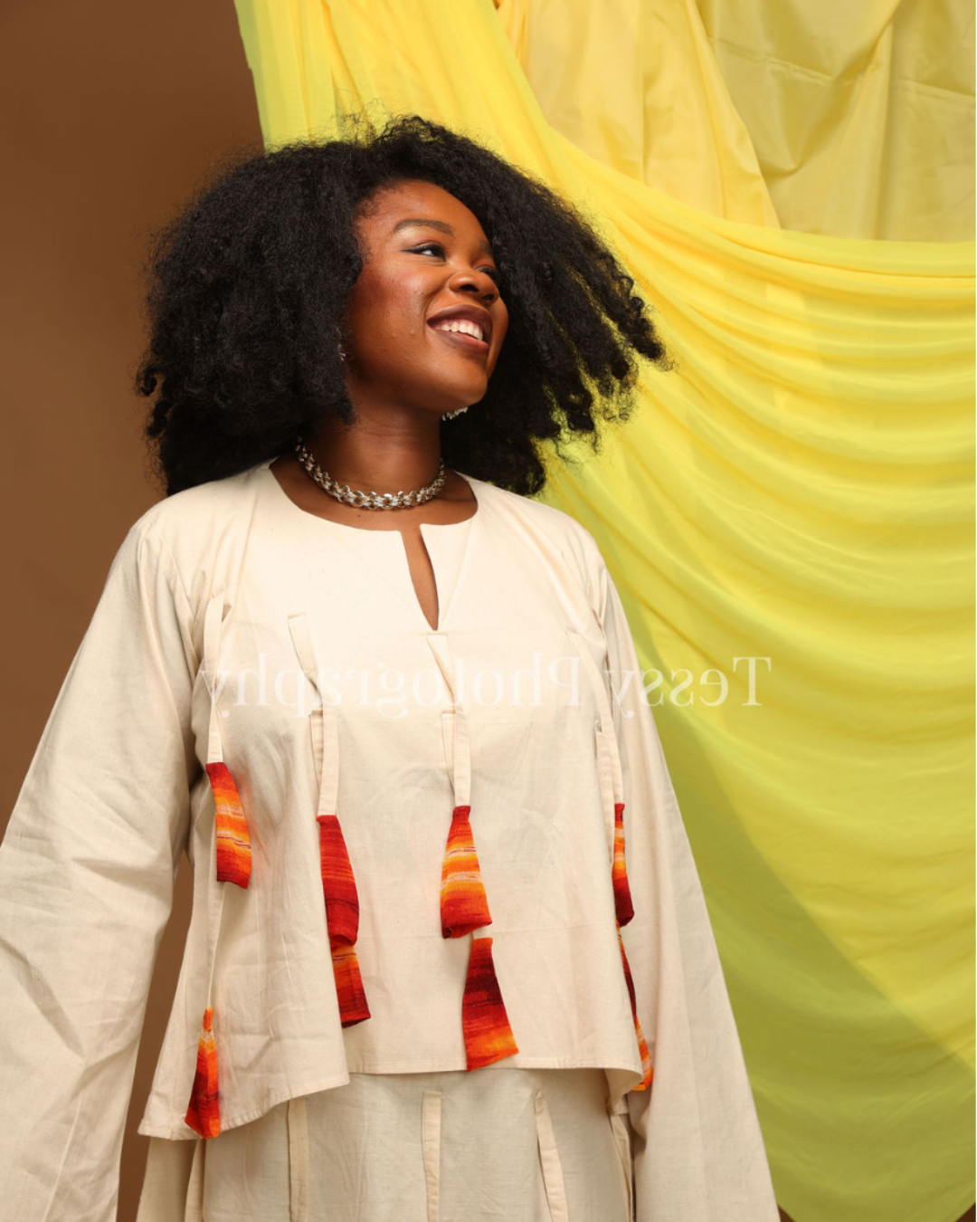Dr Mamobo Ogoro in an editorial cream outfit against a yellow backdrop