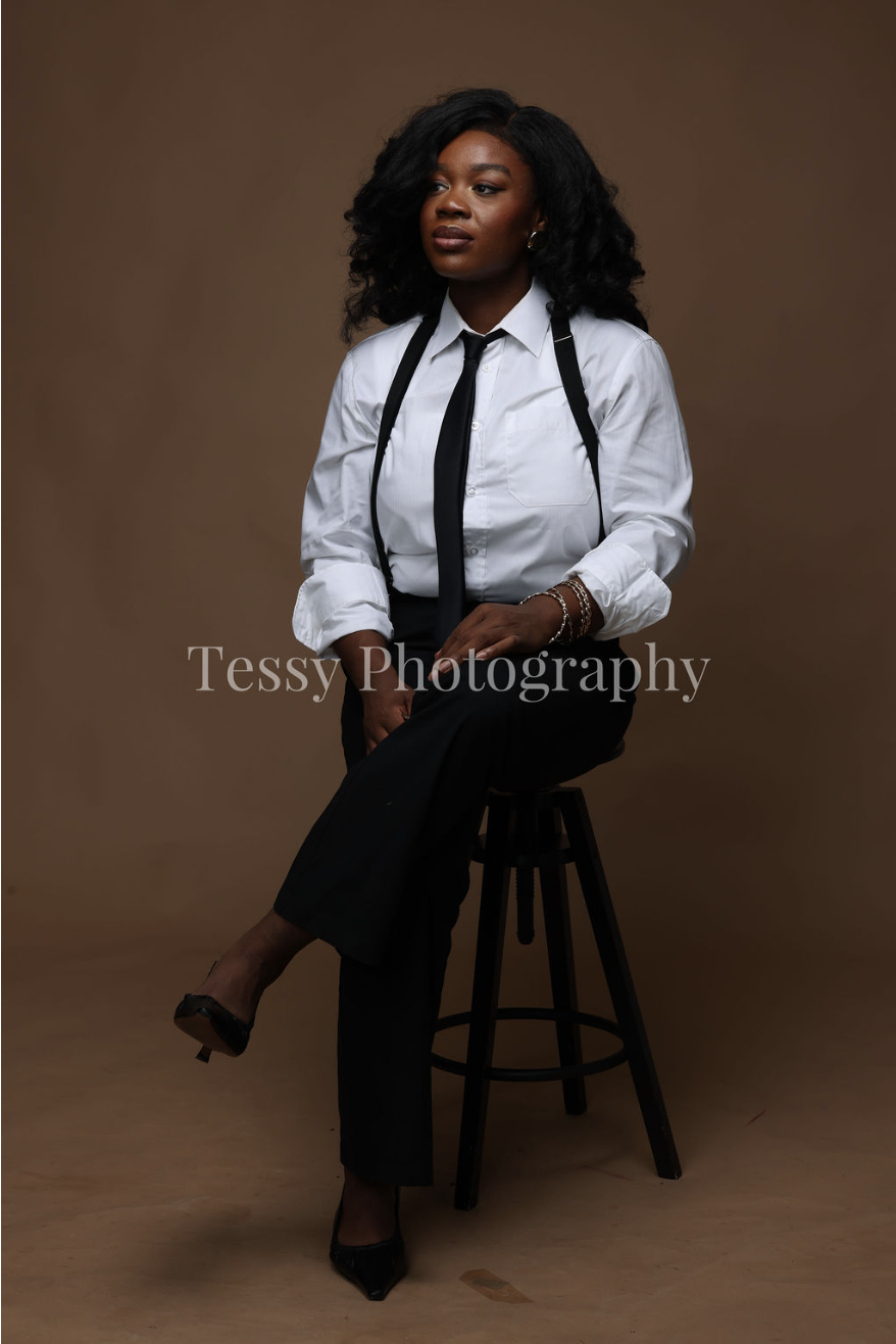 Dr Mamobo Ogoro sitting on a stool